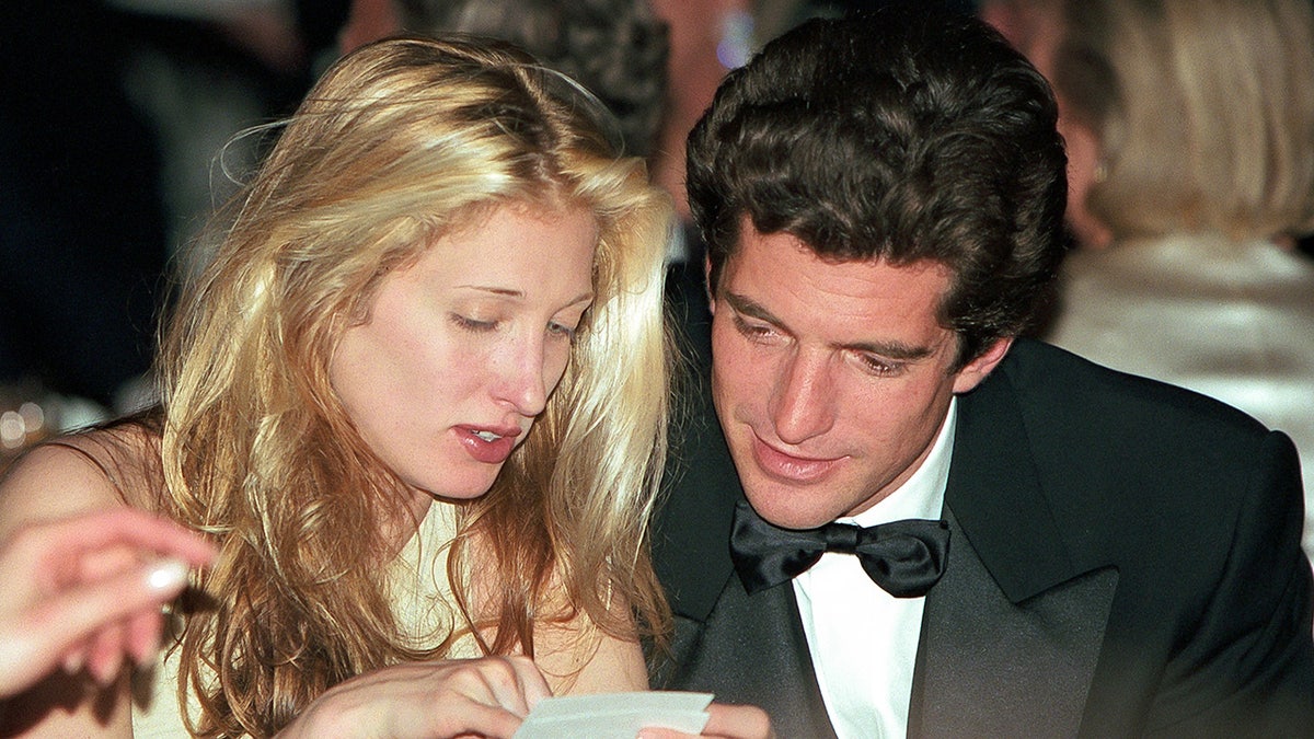 Carolyn Bessette-Kennedy sharing notes with John F. Kennedy Jr.