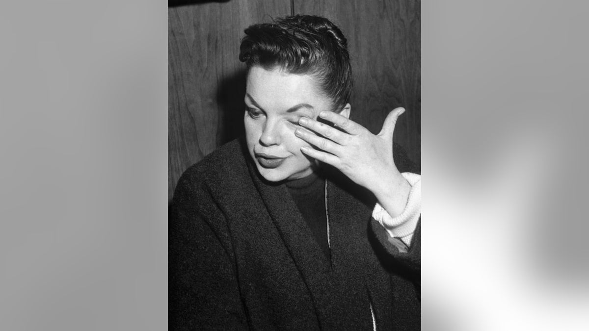 Judy Garland wiping her tears.