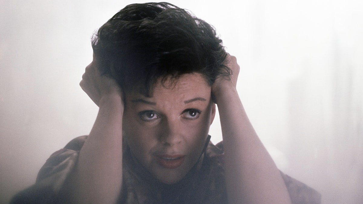 Judy Garland touching her hair