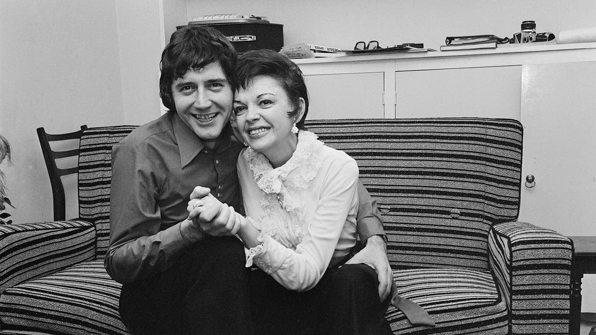Judy Garland being cradled by Mickey Deans