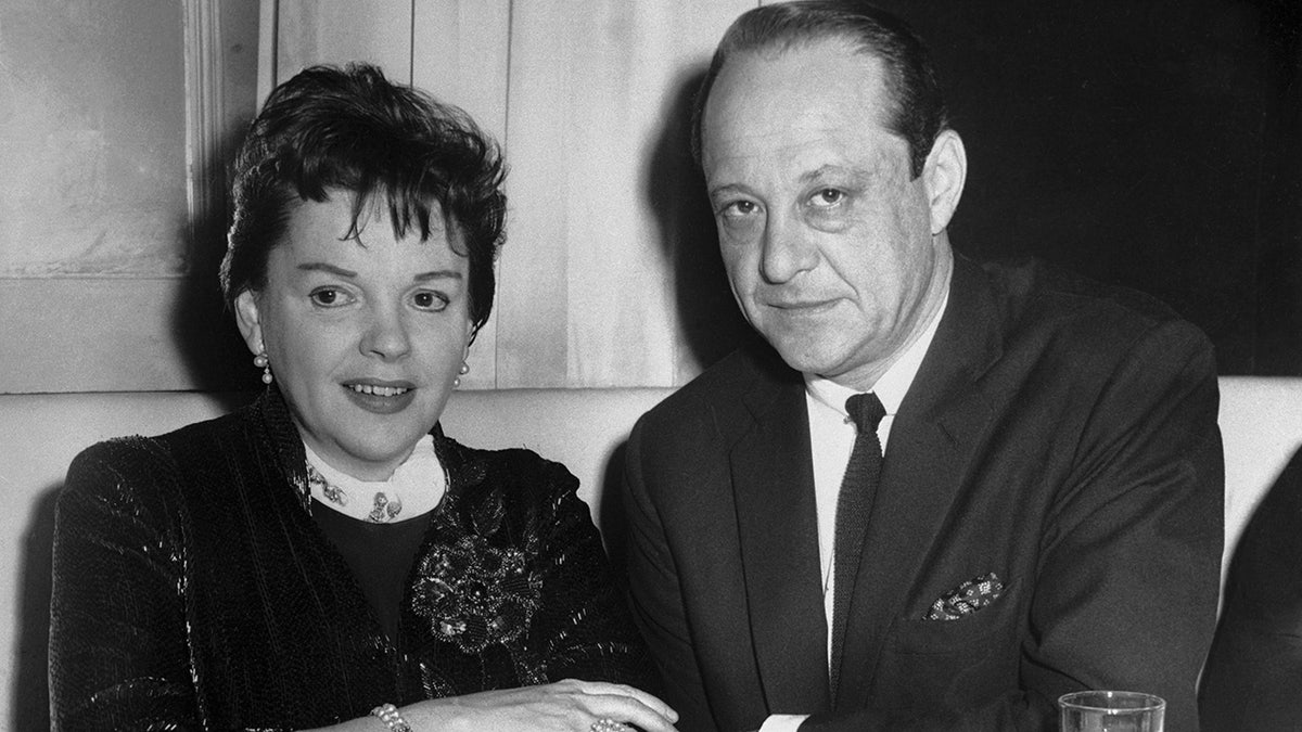 A close-up of Judy Garland and Sid Luft sitting together