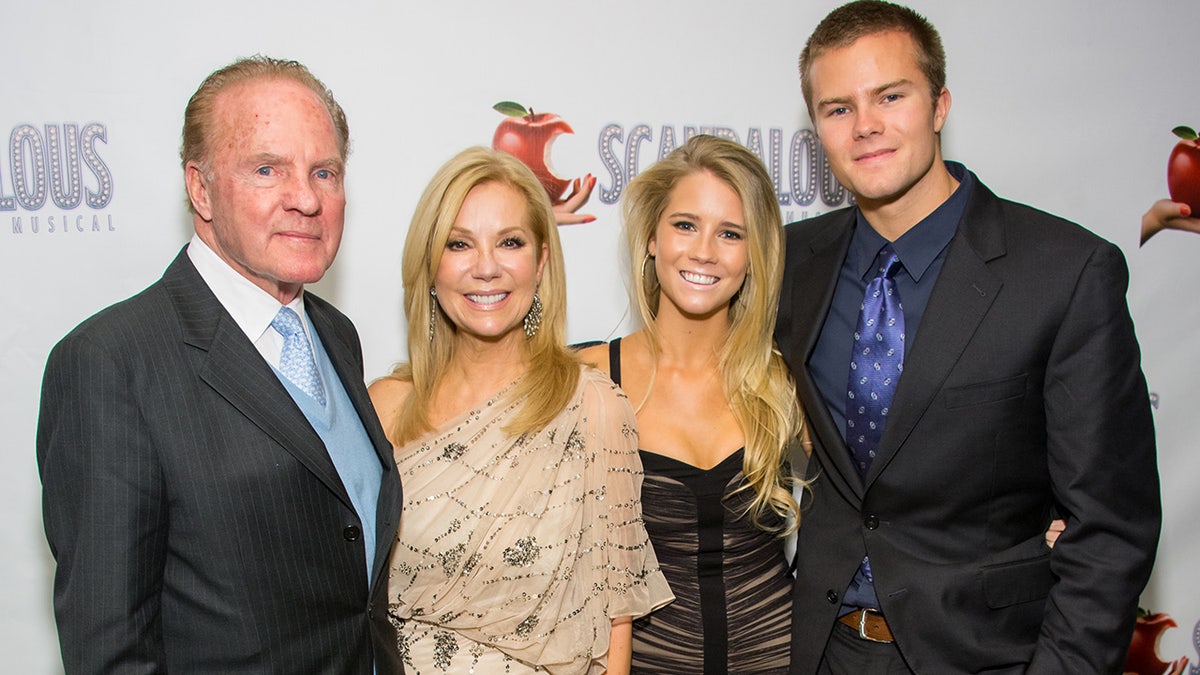 Frank Gifford and Kathie Lee Gifford smiling with their two children.