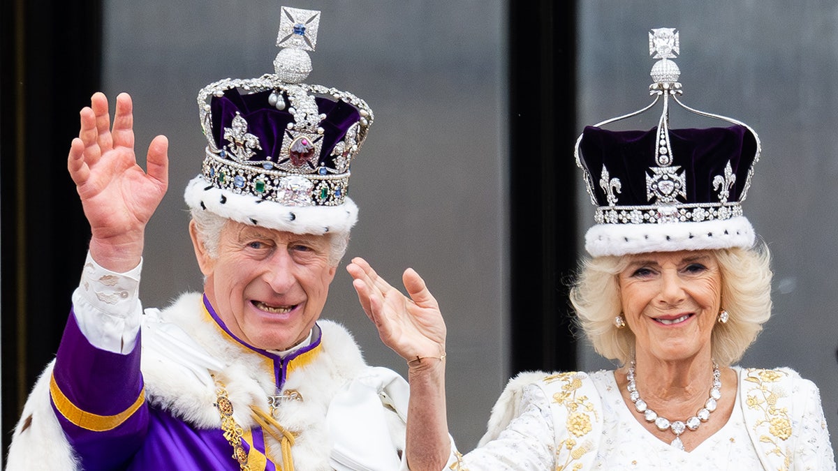 King Charles and Queen Camilla waving to the crowd after being crowned