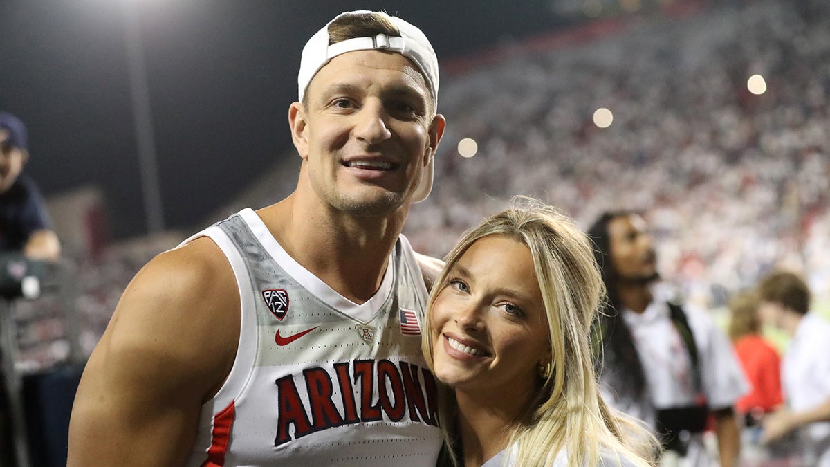 Camille Kostek and Gronk on the field after a football game