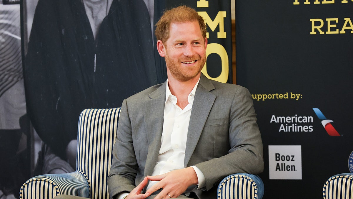 Prince Harry sitting down on a couch
