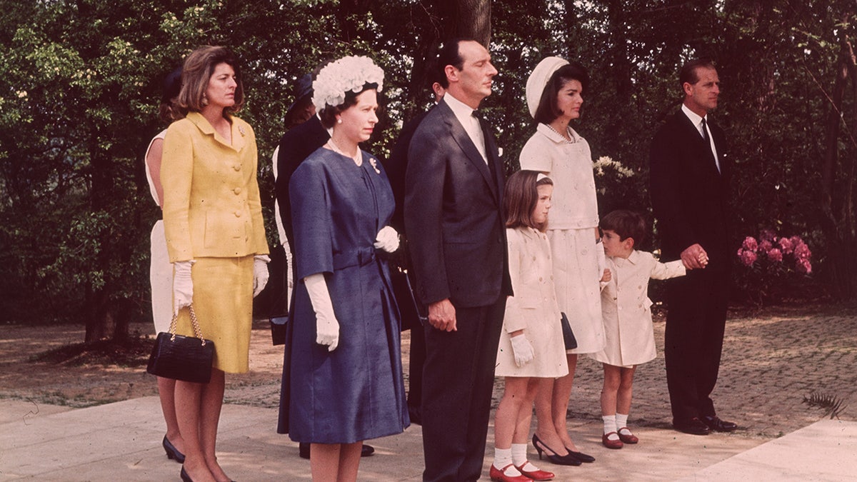 Prince Philip holding John F. Kennedy Jr.s hand