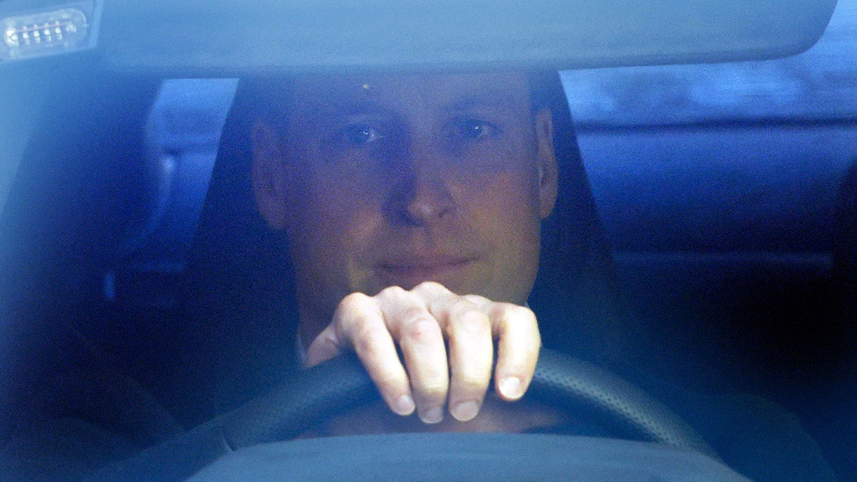 A close-up of Prince William driving.