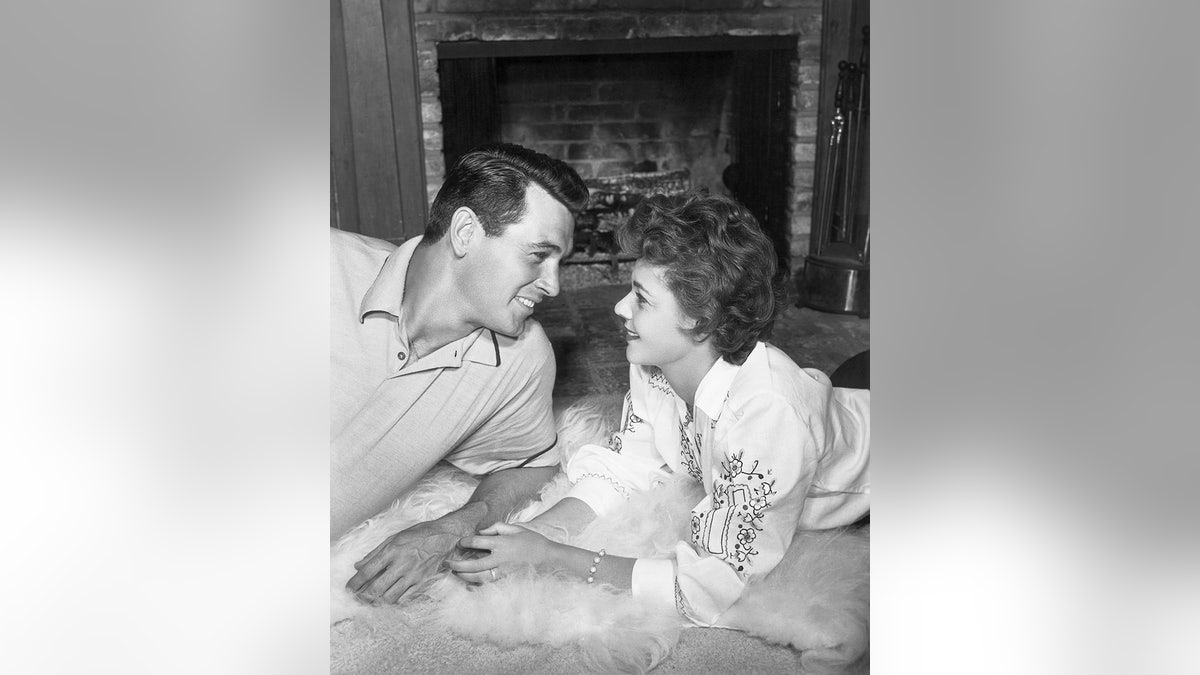 Phyllis Gates and Rock Hudson staring adoringly at each other at home
