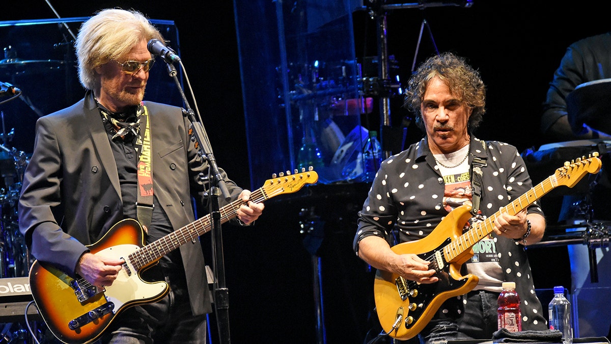 Daryl Hall and John Oates performing on stage