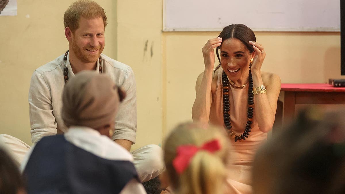 Prince Harry and Meghan are feted in a school in Nigeria