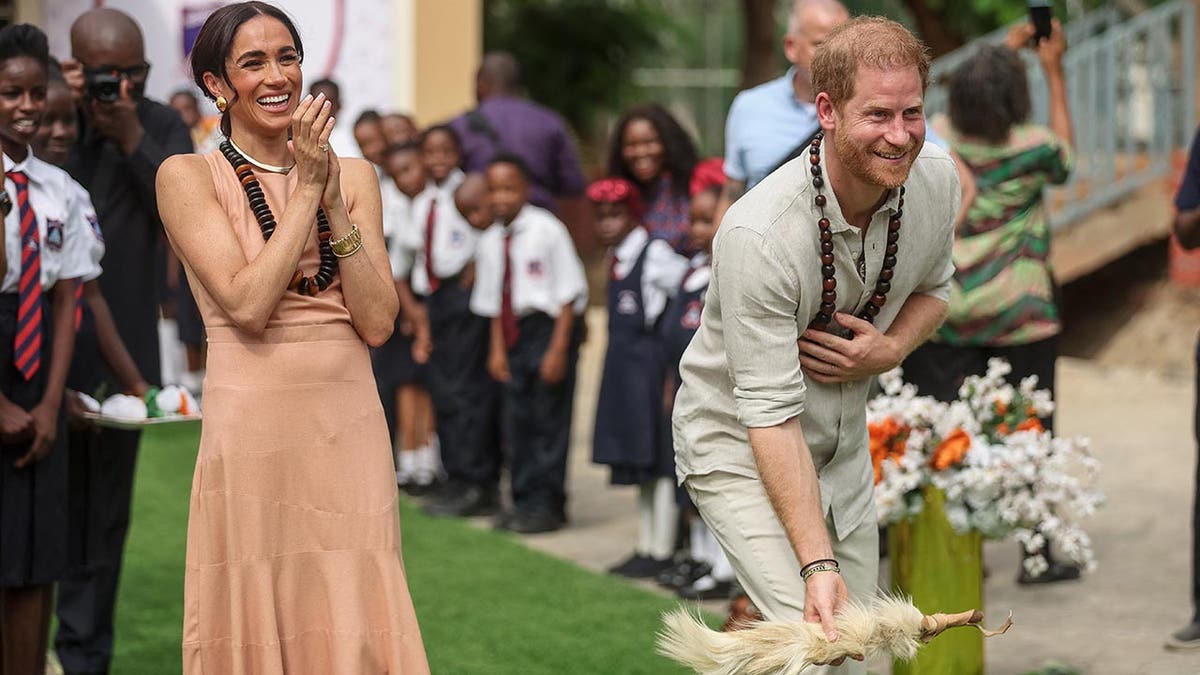 Prince Harry and Meghan are feted in a school in Nigeria