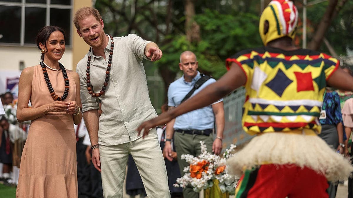 Prince Harry and Meghan are feted in a school in Nigeria