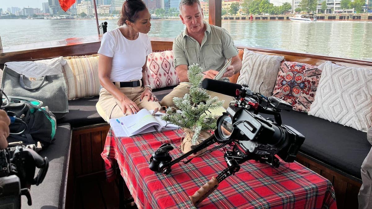 Harris Faulkner and military historian Brian DeToy on a boat in the Saigon River