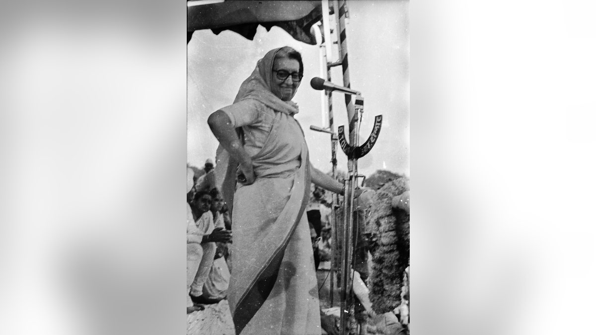 Indira Gandhi on stage with hand on hip