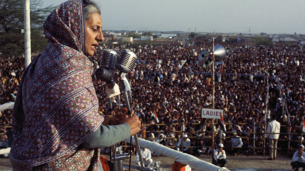 Indira Gandhi speaks into microphone to crowd
