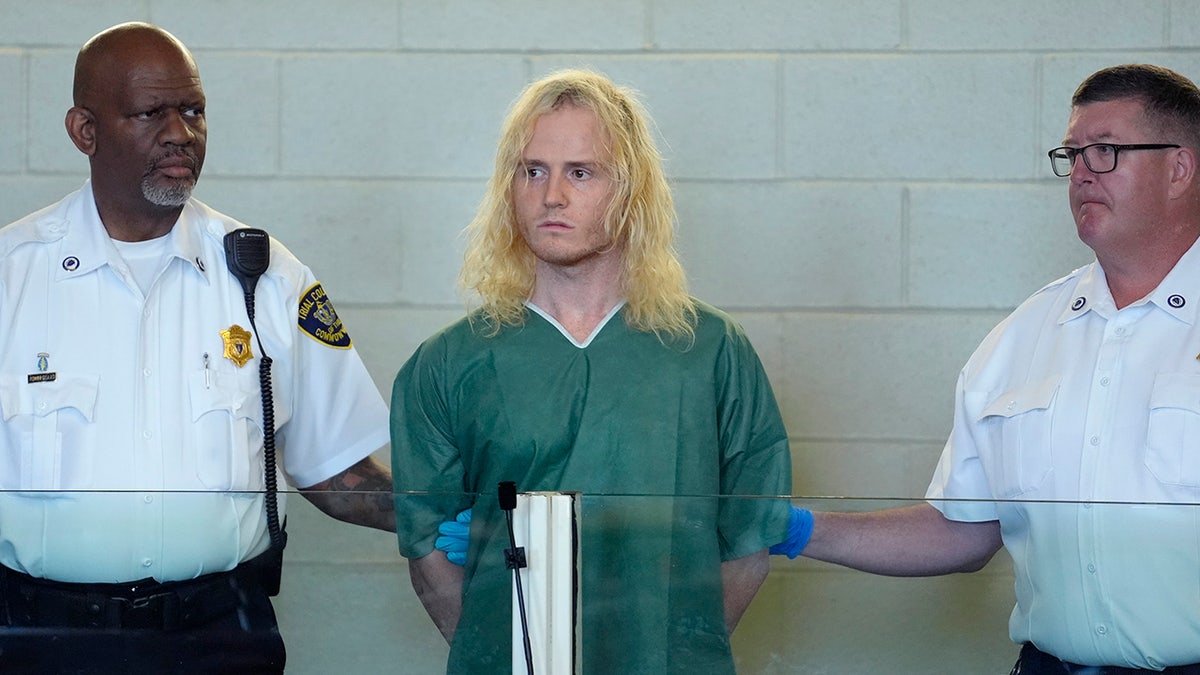 Jared Ravizza stands during his arraignment at Plymouth District Court