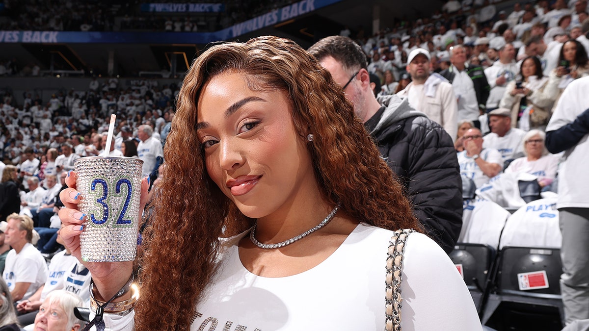 Jordyn Woods poses for picture in stands