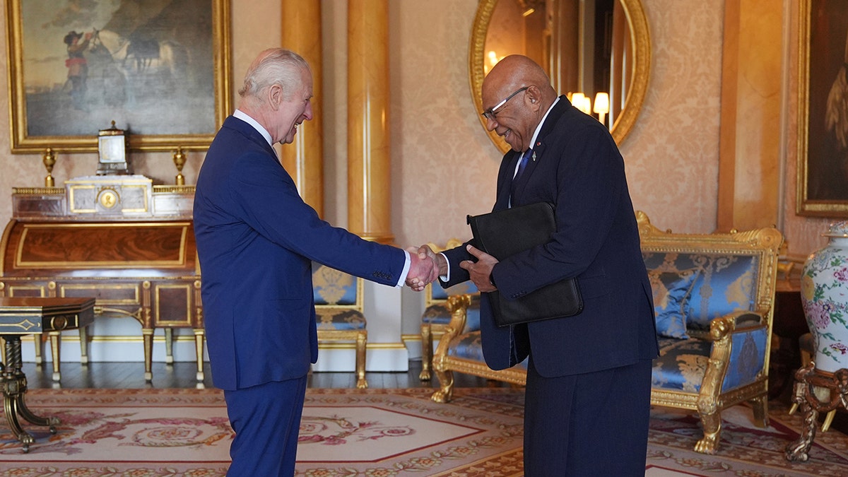 King Charles shakes hands with Fiji's prime minister