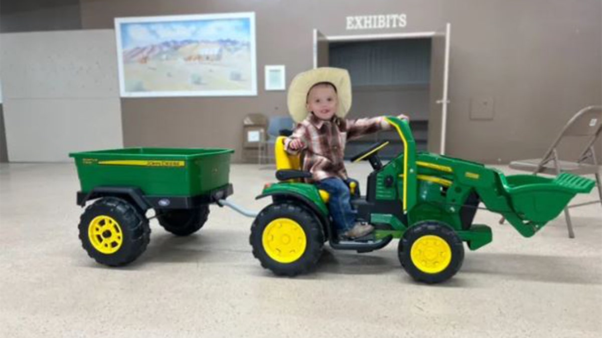 Levi Wright on his toy tractor