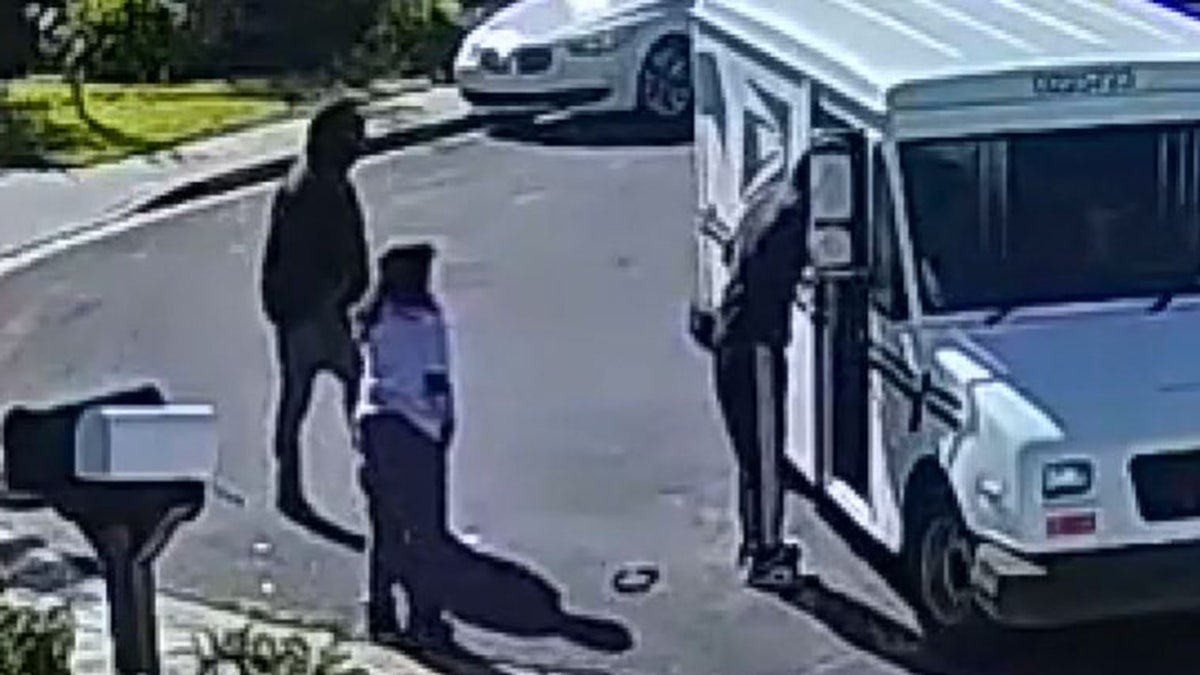 Robber grabbing keys from mail truck
