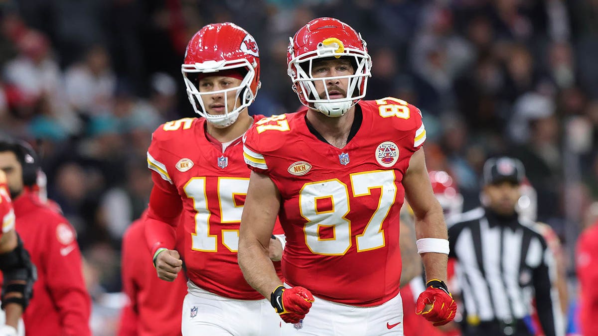 Patrick Mahomes and Travis Kelce jog during an NFL game