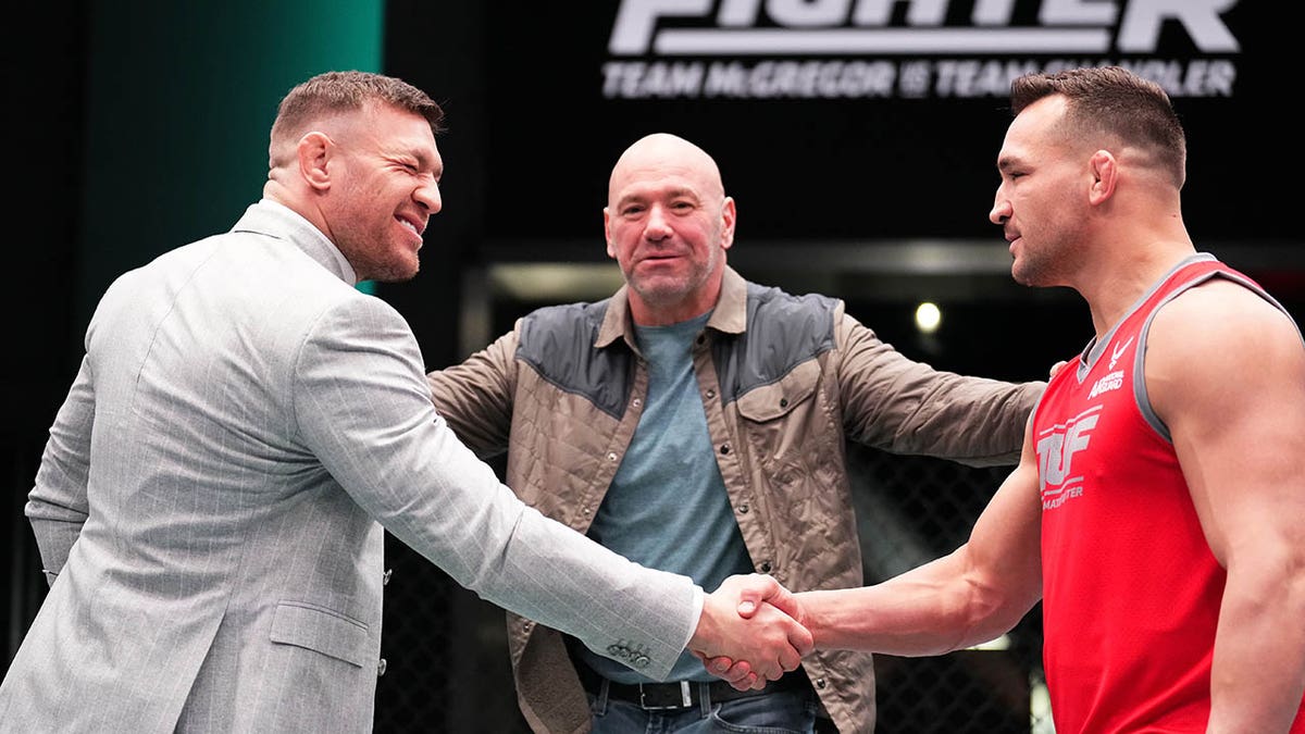 Conor McGregor shakes hands with Michael Chandler