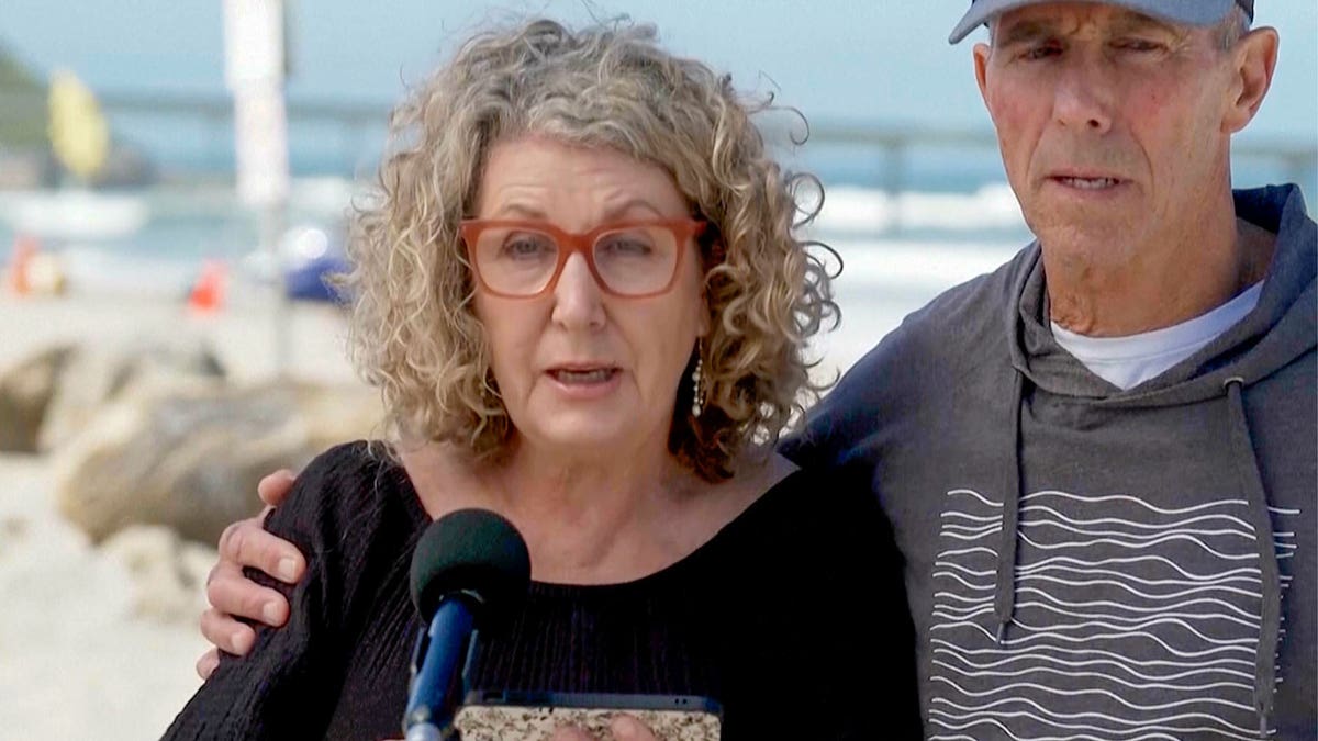 Australian Debra Robinson with her husband Martin address the media on the beach in San Diego after the death of her two children in Mexico during a surfing trip.