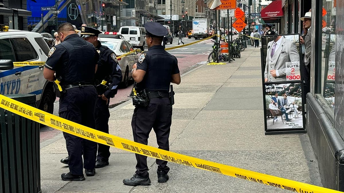 Police behind the crime scene adhesive tape in the street in New York City