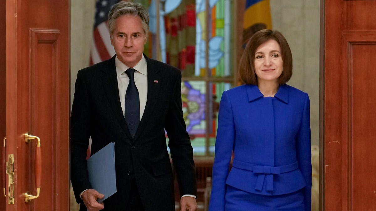 United States Secretary of State Antony Blinken, left, and Moldova's President Maia Sandu, right, arrive to give a joint press conference at the Moldovan Presidency in Chisinau, Moldova.