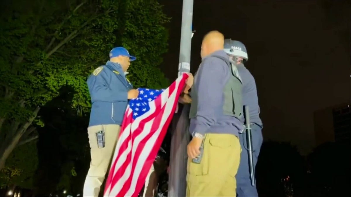 American flag being raised after its removal