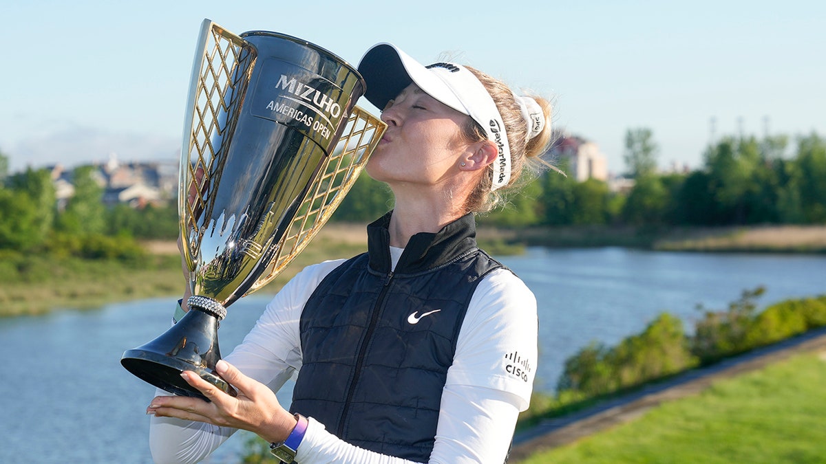 Nelly Korda poses with a trophy