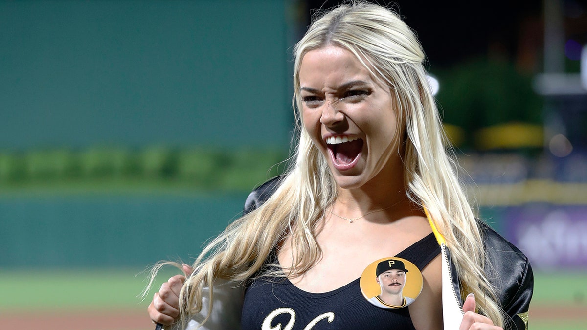 Olivia Dunne shows off "Yinz" shirt at Pirates game