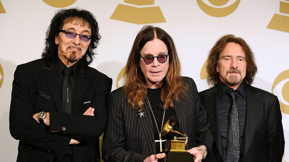 Tony Iommi, Ozzy Osbourne and Geezer Butler of Black Sabbath pose with Grammy award