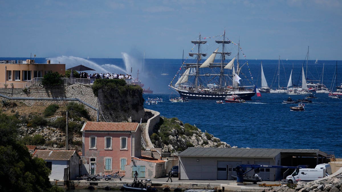 The Belem, the three-masted sailing ship which is carrying the Olympic flame, is accompanied by other boats approaching Marseille