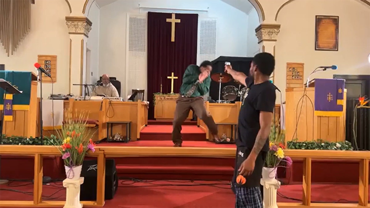 Man points gun at pastor in front of church