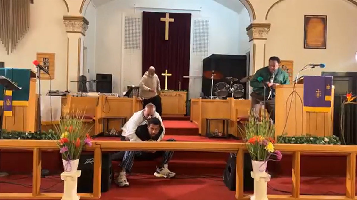 Churchgoer holds gunman's arm down