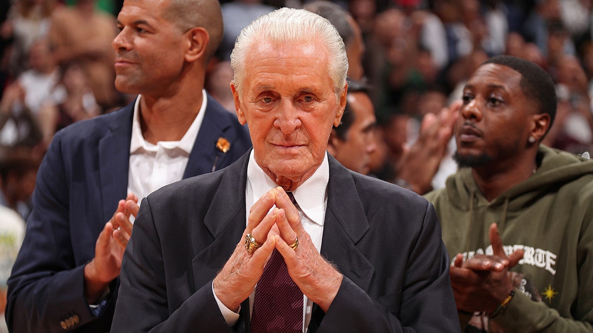 Pat Riley with prayer hands on court