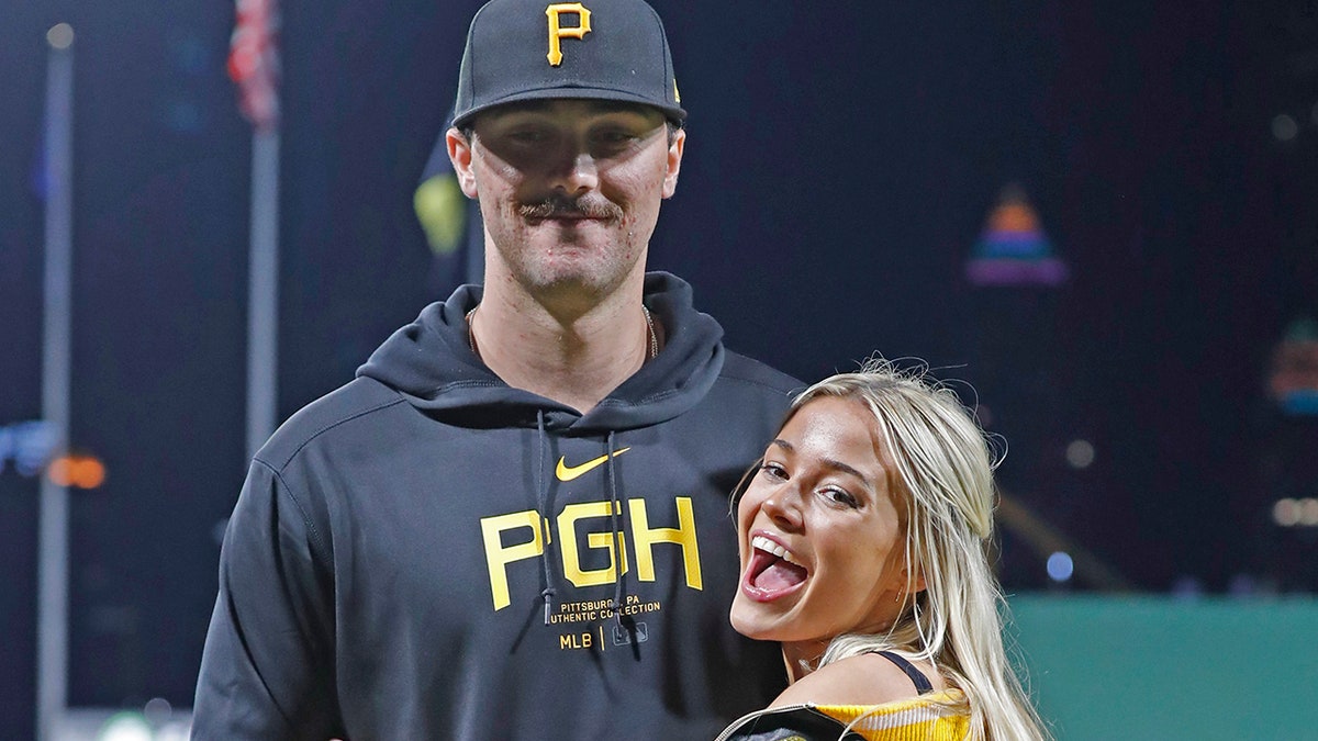 Paul Skenes and Olivia Dunne pose on the PNC Park field