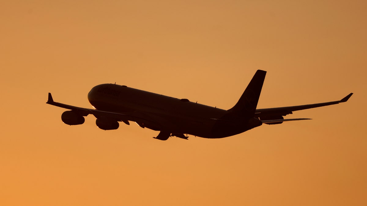 A Lufthansa Airbus A340-313 aircraft departs from Los Angeles International Airport at sunset
