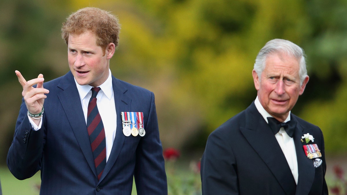 Prince Harry and King Charles standing next to each other