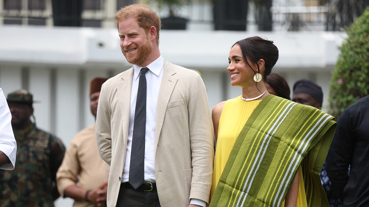 Prince Harry and Meghan Markle walking hand in hand in Nigeria