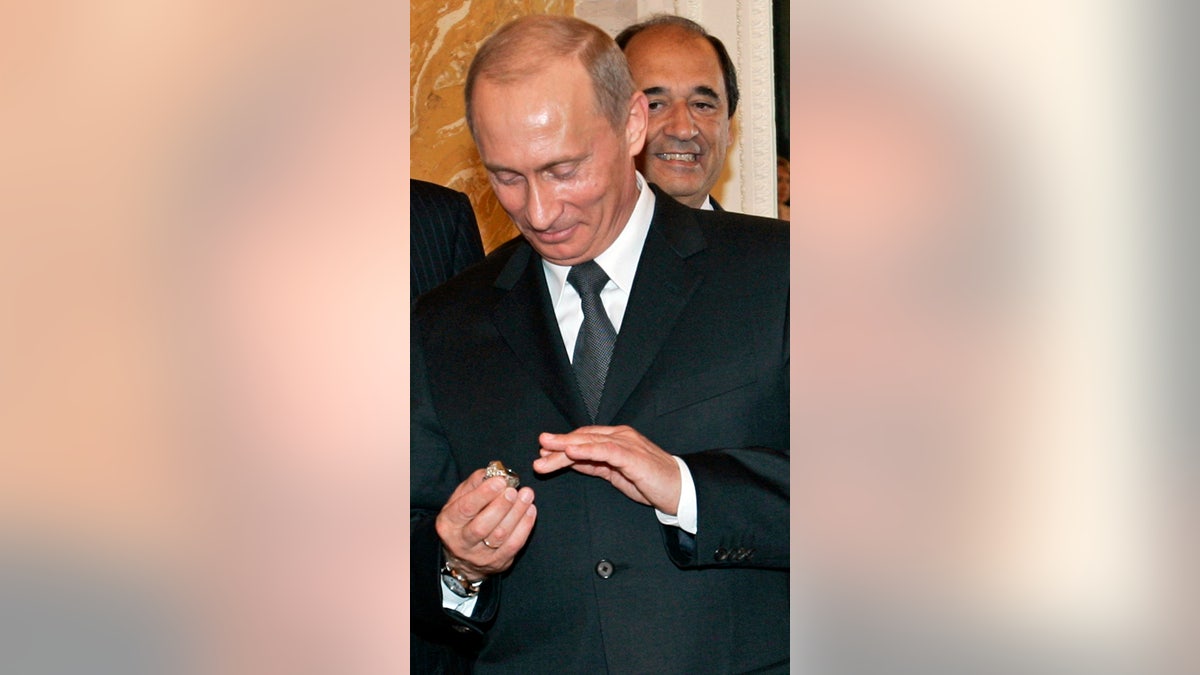 Putin tries on a Super Bowl ring