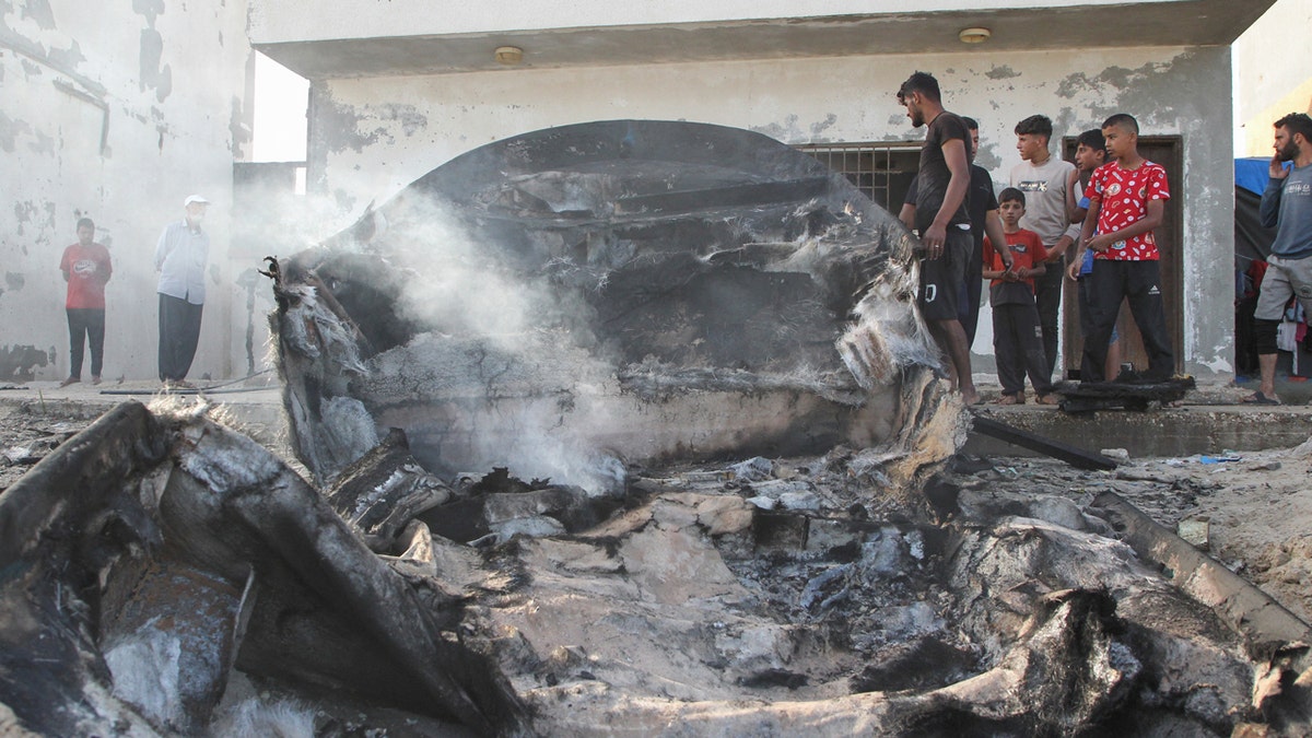 Palestinians inspect boats damaged in Israeli fire