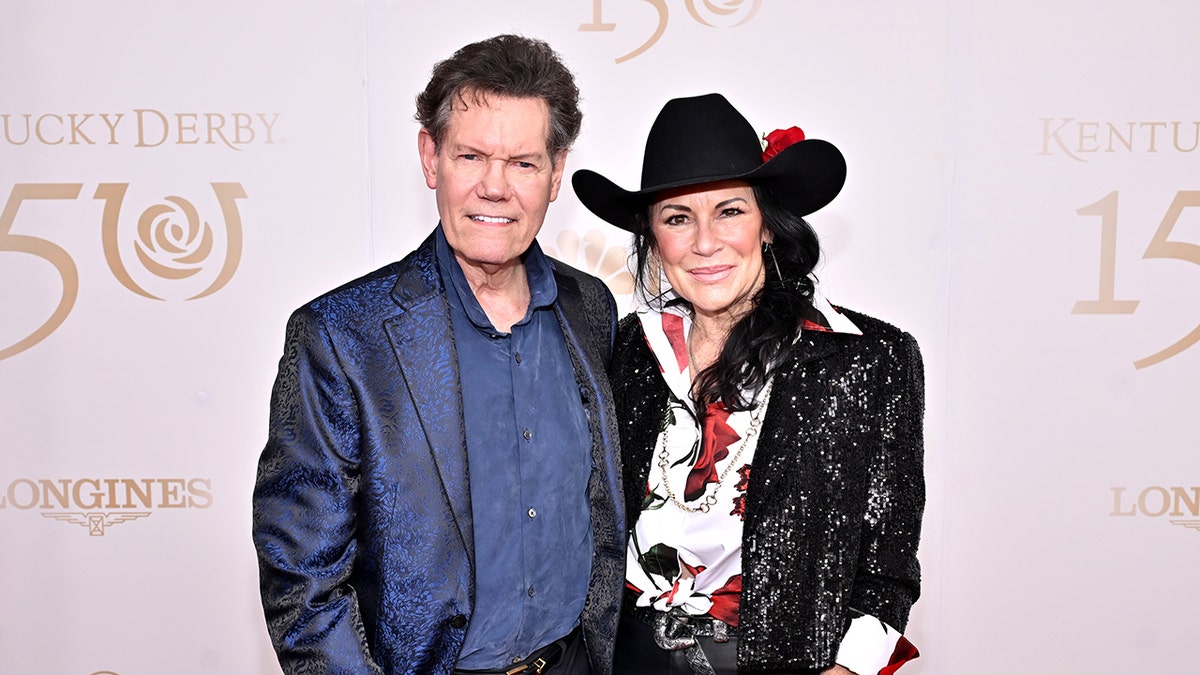 Randy Travis and Mary Travis posing together at the Kentucky Derby