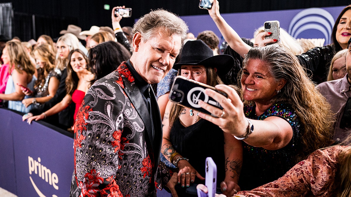 Travis took photos with fans at the recent 59th Academy of Country Music Awards at The Star in Frisco, Texas.