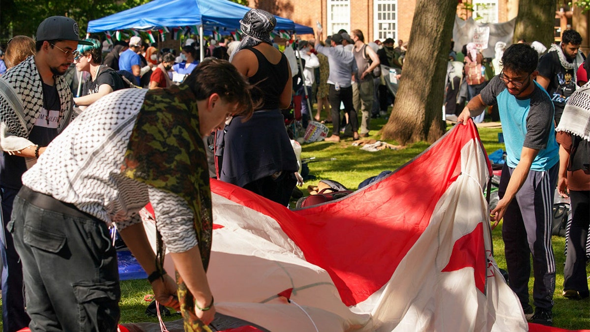 Rutgers students counter anti-Israel agitators on campus by waving American flag, chanting 'USA! USA!'  at george magazine