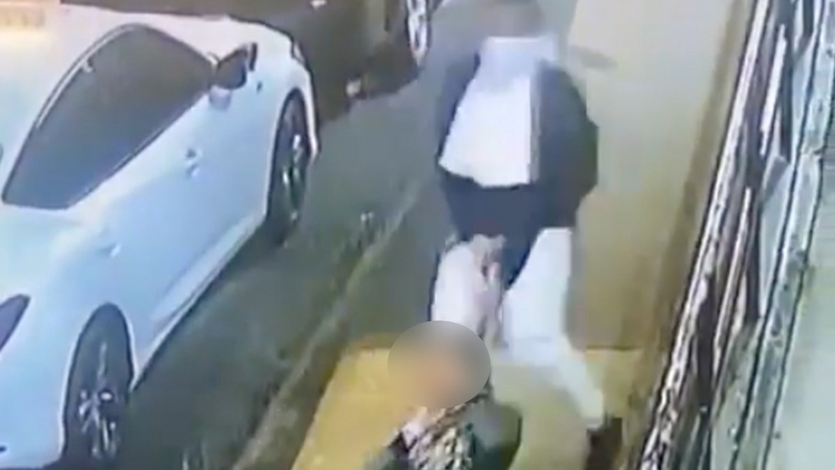 Masked man drags woman down street with belt around her neck