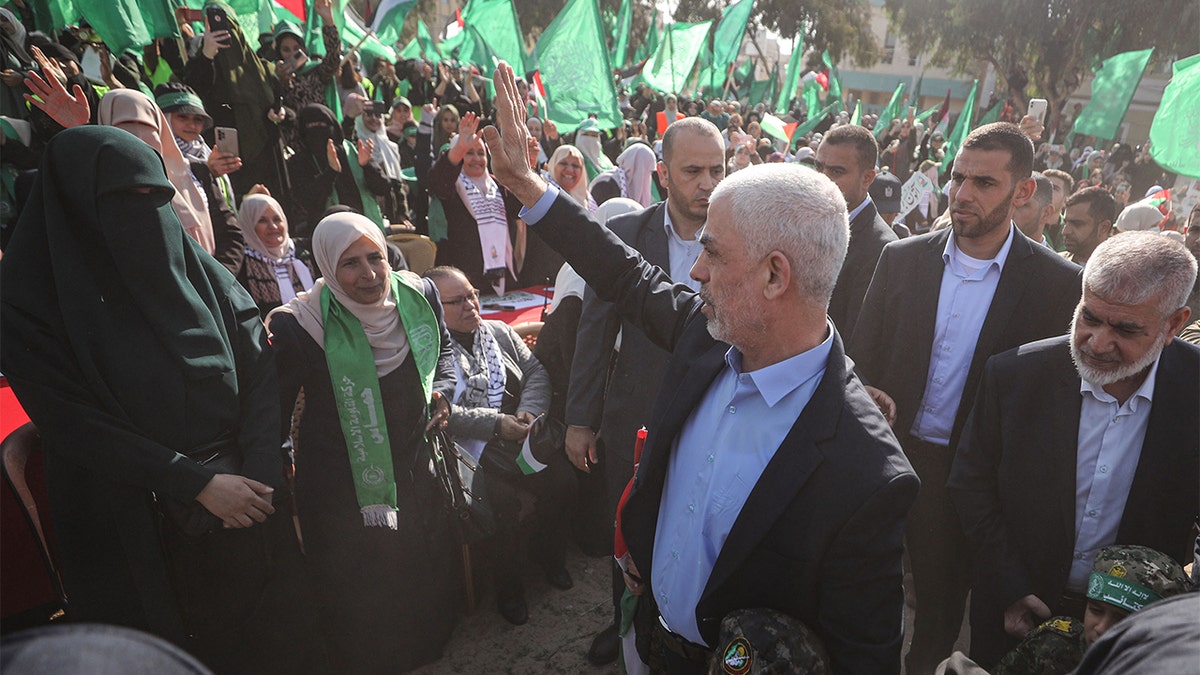 Sinwar waving at a group of supporters at a rally.