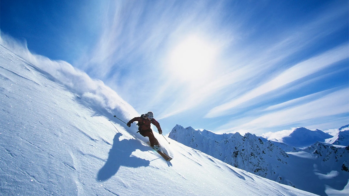 Skier Skiing On Mountain Slope