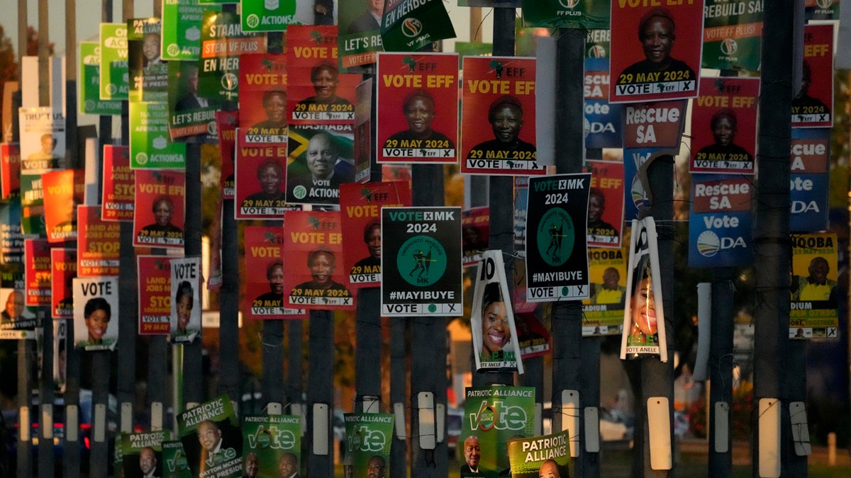 An array of election posters from various political parties are displayed on poles in Pretoria, South Africa